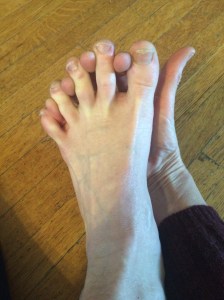 Inserting my fingertips between my toes at the distal joints. 